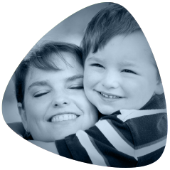 Boy with his mother smiling. Senova Dental Studios is a general dentist in Watford, Hertfordshire.