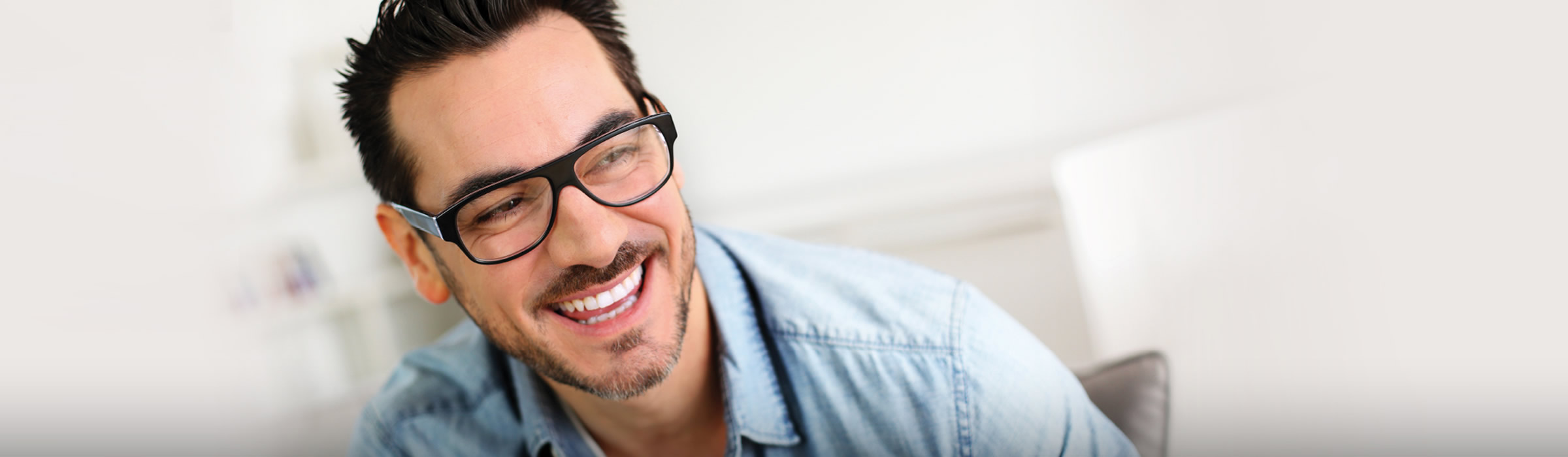 Man in glasses smiling. Teeth whitening dentist near me in Watford, Hertfordshire.